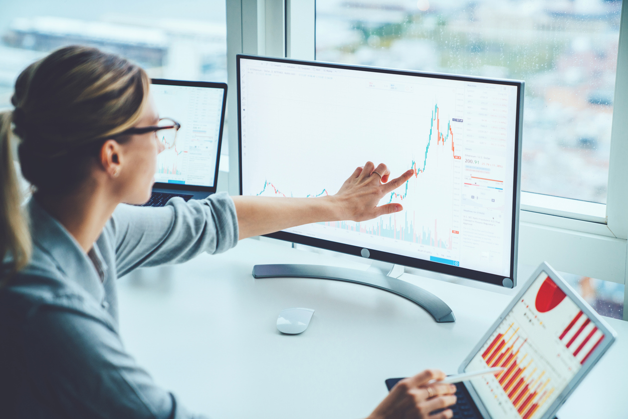 Woman studying data charts on a computer