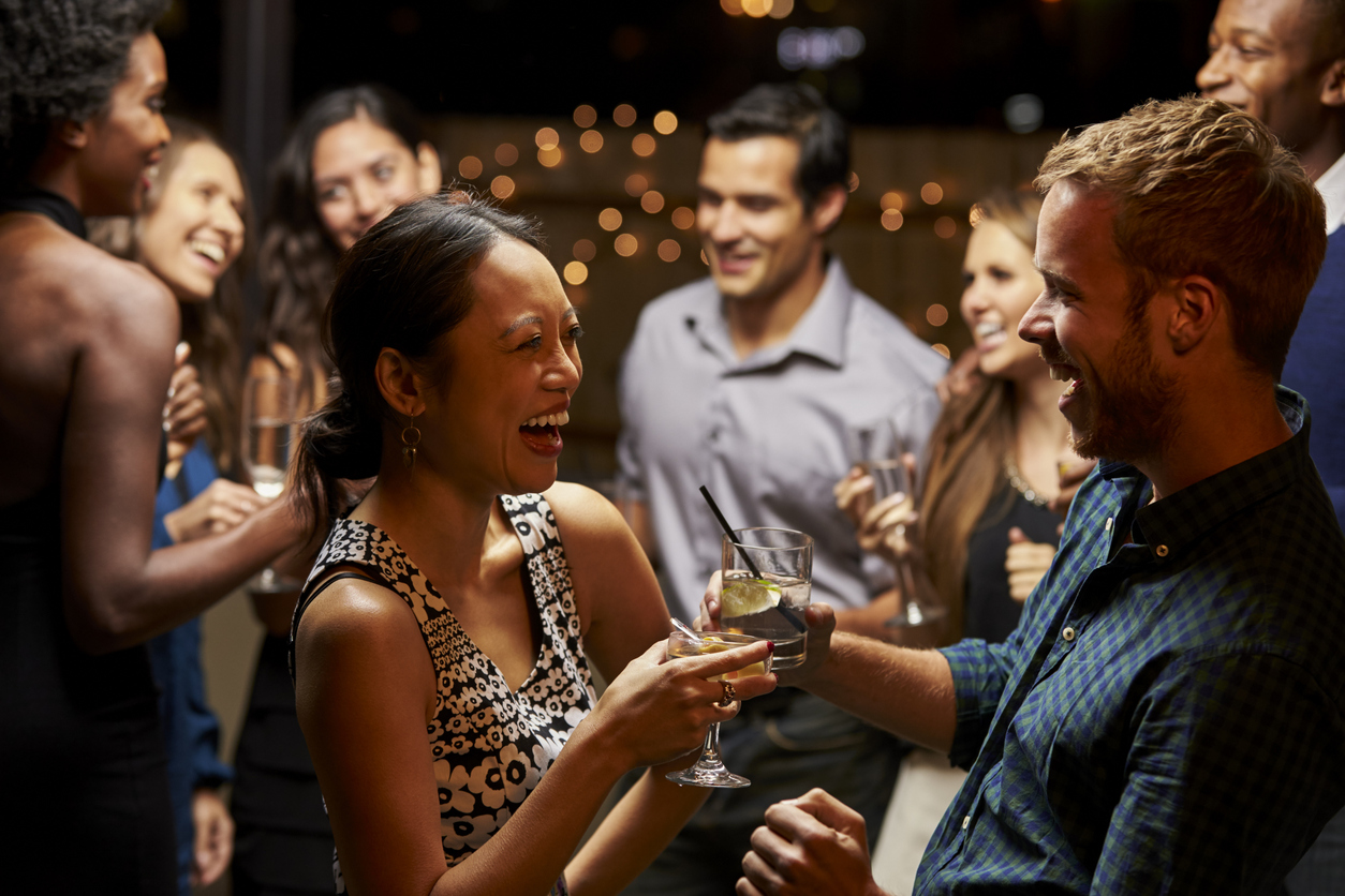 Alumni chatting at an evening networking event.